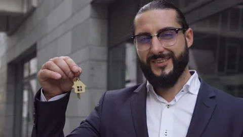 Happy handsome man bragging with key from new apartment, house leasing program Stock Footage 163351366