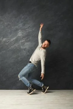 Happy handsome man dancing in studio Foto stock