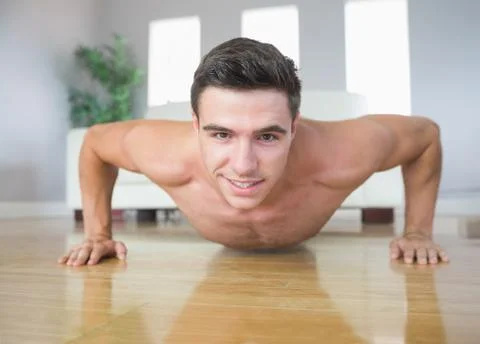 Happy handsome man doing push ups Stock Photos