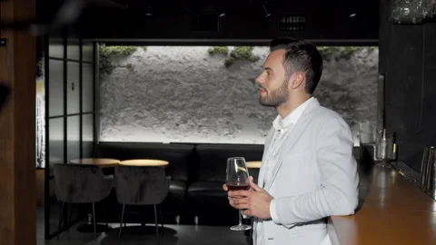 Happy handsome man smiling to the camera raising his wine glass Stock Footage 132442773