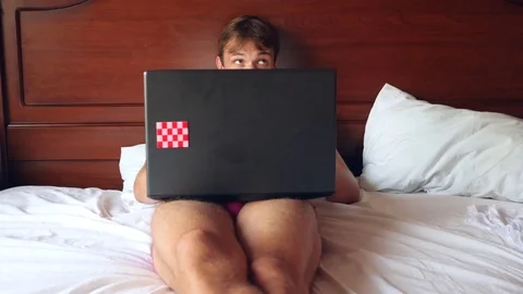 Happy handsome man working in bed in bright bedroom. 4k, slow motion Stock Footage 80178795