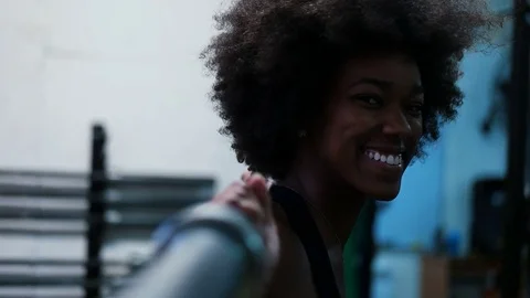 Happy healthy african american woman working out in a crossfit gym on weight  Stock Footage