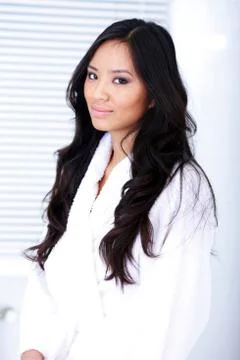 Happy healthy asian woman in white bath robe Stock Photos