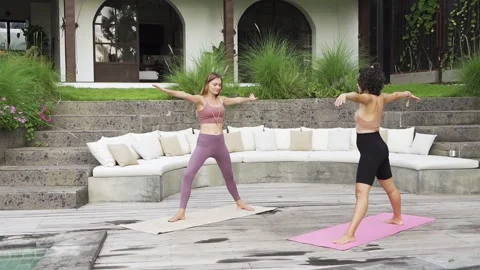 Happy healthy two woman training and practicing yoga pose at home on the weekend Stock Footage 140976341