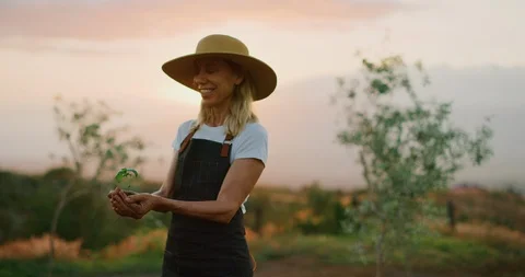 Happy with her new basil herb plant Stock Footage 107038357