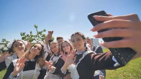 Happy high school graduates take a selfie on a sunny day. Stock Photos