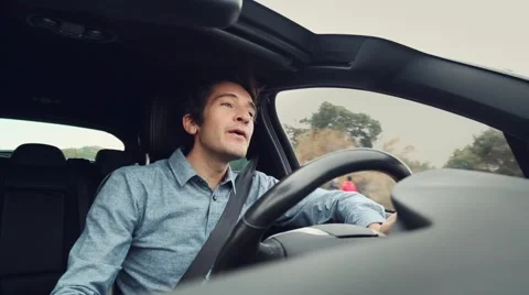 Happy hip man dancing and singing while driving car Stock Footage 58211383