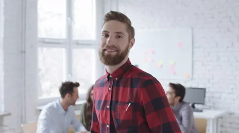 Happy hipster looking at camera standing in office Stock Footage 64625659