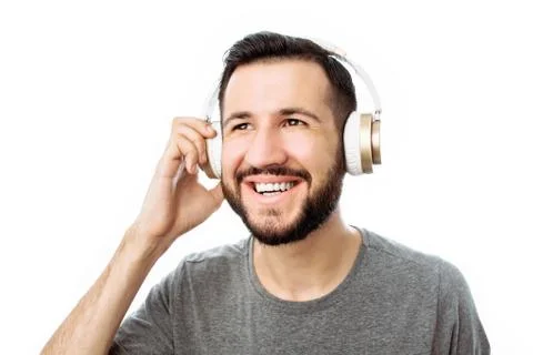 Happy hipster man, smiling while listening to music on headphones. on white b Stock Photos