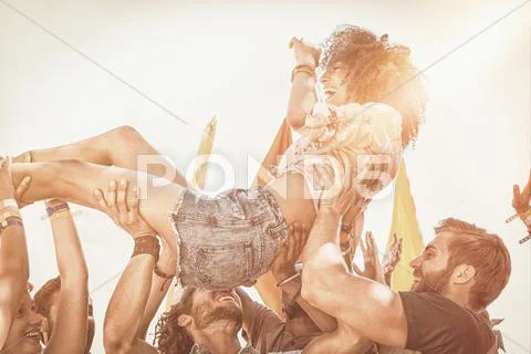 Happy hipster woman crowd surfing Stock Photos