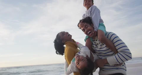 Happy hispanic family having fun on beach at sunset Stock Footage 336436005