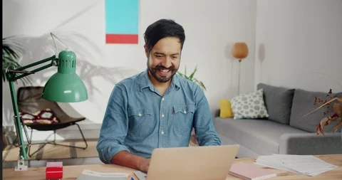 Happy Hispanic guy using laptop receiving good successful email job message in Stock Footage 120743966