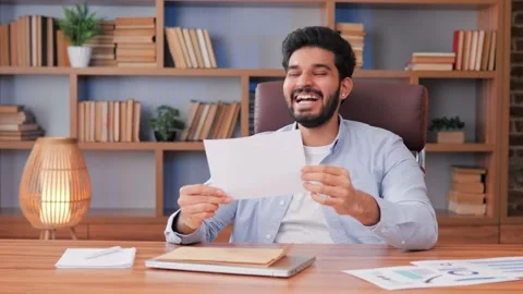 Happy hispanic man reading good news excited happy winner received job contract. Video stock 237992710