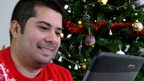 Happy hispanic man talking with his family and smiling through a tablet. Stock Footage 140829346