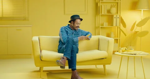Happy Hispanic man typing a message on the mobile phone while smiling and Stock Footage 171445499