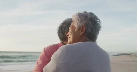 Happy hispanic senior couple dancing on beach at sunset Stock Footage 337293517