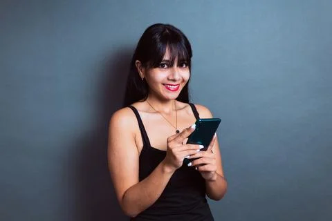 Happy hispanic student using cell phone. young business woman chatting Photos