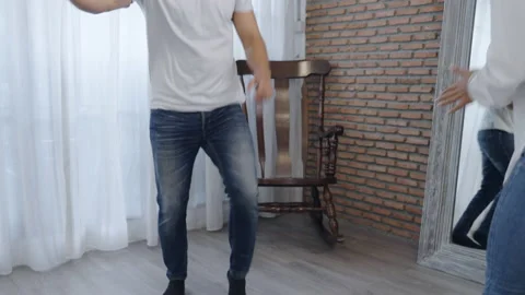 Happy Hispanic young couple having fun dancing samba in bedroom Video stock 166034964