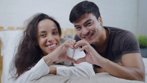 Happy Hispanic young couple making a heart shape with hands Stock Footage 166035728
