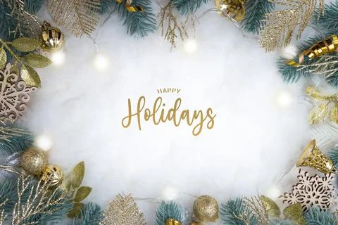 Happy Holidays text with frame made of Christmas decorations flat lay on sn.. Stock Photos