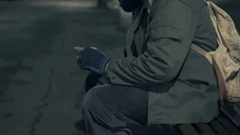 Happy homeless on a bench after counting his money Stock-Footage 84037341