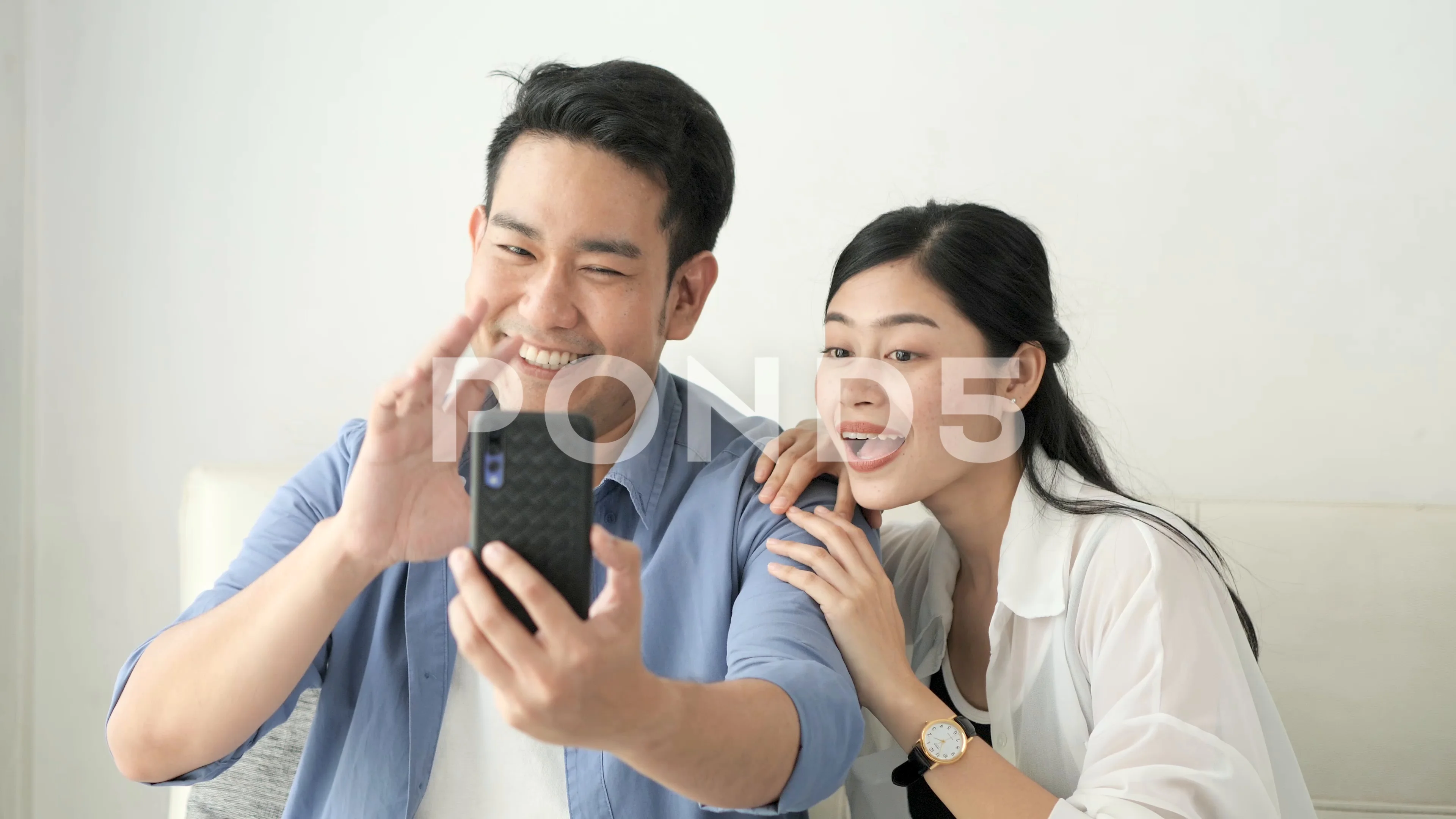 Happy honeymoon couple making video call to their family for lifestyle