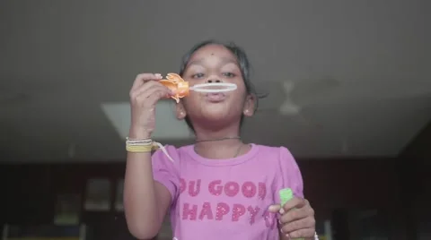 Happy Indian Child Making Bubbles and Laughing Stock Footage 57972328