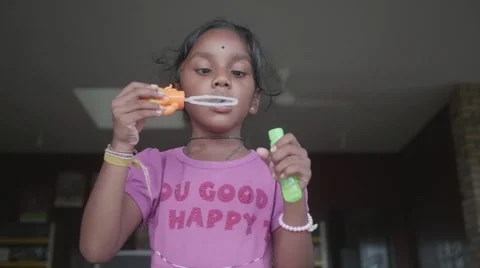 Happy Indian Child Making Bubbles and Laughing Stock Footage 57972365