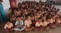 Happy Indian children in uniforms sitting on the floor HD Footage