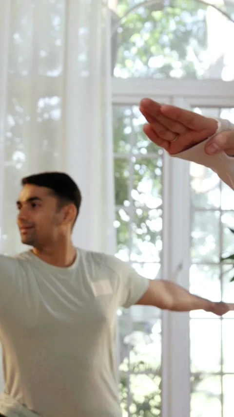 Happy Indian couple practicing yoga ina beautiful home Stock Footage 343405526