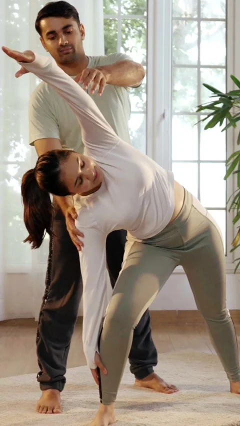 Happy Indian couple practicing yoga ina beautiful home Stock Footage 343405649