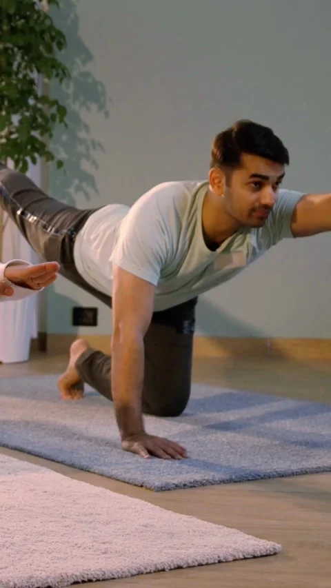 Happy Indian couple practicing yoga ina beautiful home Stock Footage 343405689
