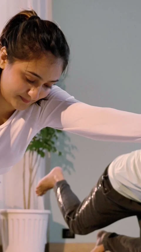 Happy Indian couple practicing yoga ina beautiful home Stock Footage 343405692