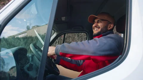 Happy indian courier using tablet in the van Stock Footage