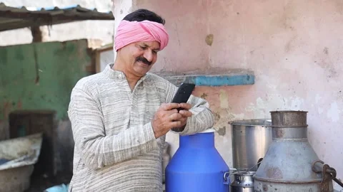 Happy indian dairy farmer using smart phone, Farming industry business, Tec.. Stock Footage 282579948