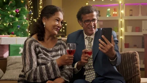 Happy Indian Elderly couple talking on video call over mobile phone on Christmas Vidéo 222535728