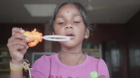 Happy Indian Girl Making Bubbles and Laughing Stock Footage 57972392