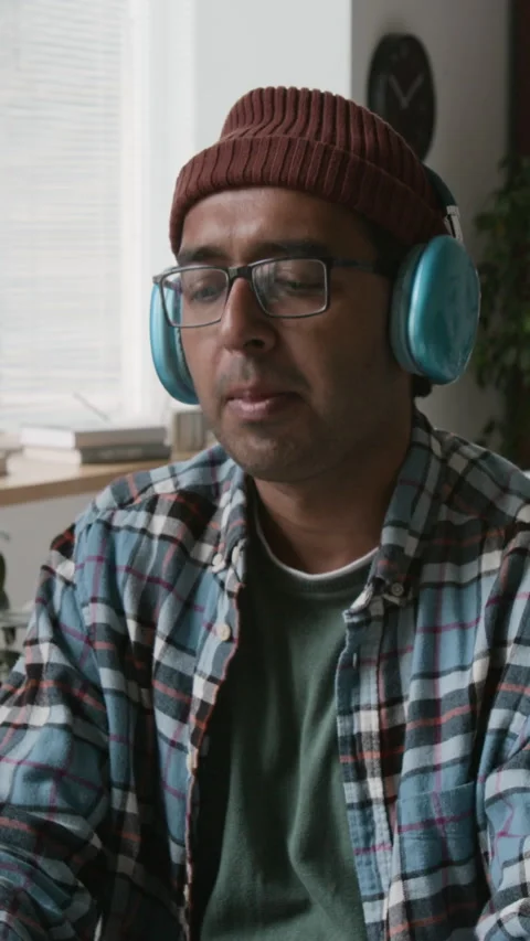 Happy Indian Male Developer Coding and Enjoying Music at Work Stock Footage 286074232