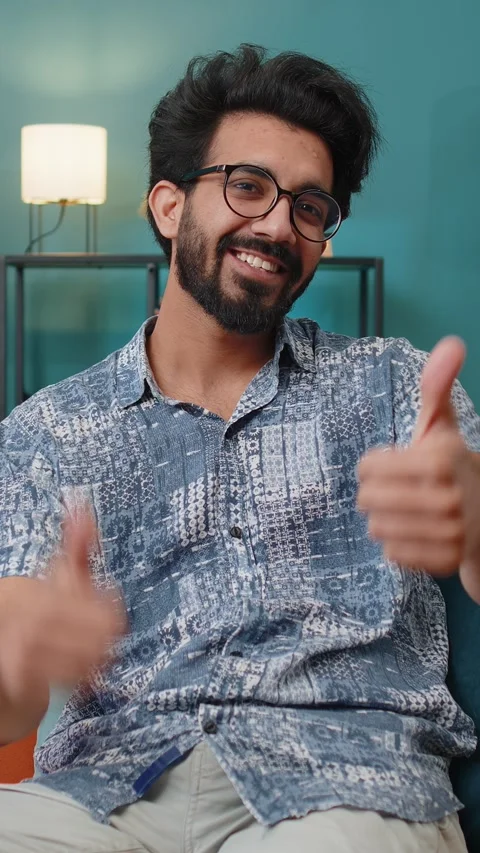 Happy Indian man looking approvingly at camera showing thumbs up, like positive Stock Footage 347055745