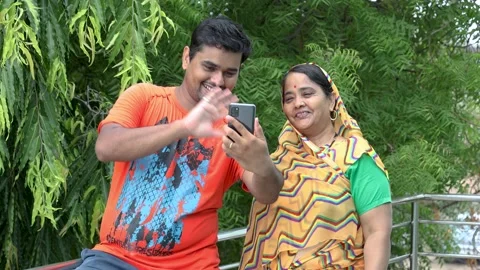 Happy indian mother and son doing video call with mobile phone Stock Footage