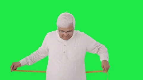 Happy Indian old man measuring waist using inch tape Green screen Vídeo Stock 280383479