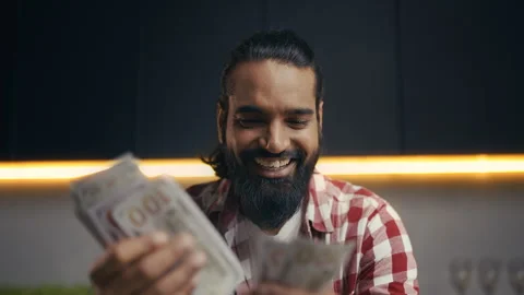 Happy Indian programmer counting profit after successful freelance IT project Stock Footage 313281409