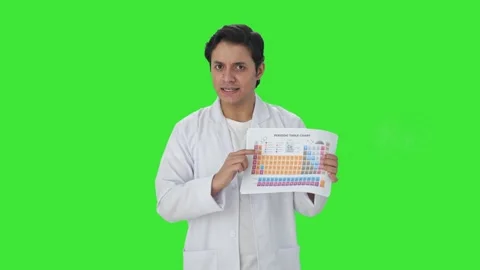 Happy Indian scientist explaining periodic table Green screen Stock Footage 253558529