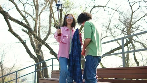 Happy influencers using selfie stick to make vlog unpacking for followes Stock Footage 277193655