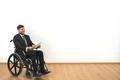 The happy invalid holding papers on the white wall background Photo