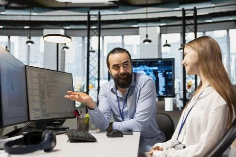 Happy IT professional teaching intern to use artificial intelligence 스톡 사진