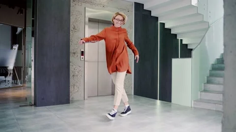 Happy joyful young and attractive woman dancing victory dance in corridor  Stock Footage 239021459