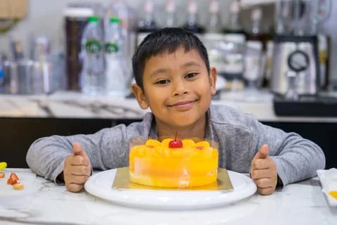 Happy kid boy making a cake Stock Photos