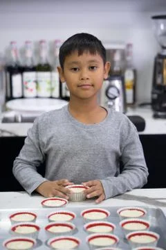 Happy kid boy making a cake Stock Photos