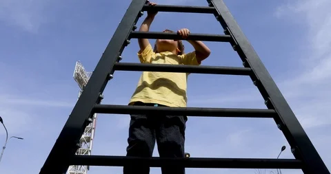 Happy kid having fun climbing on ladder Stock Footage 107547287